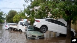 Vehicles sit in a flooded street after a storm in Bahia Blanca, Argentina, March 7, 2025. 