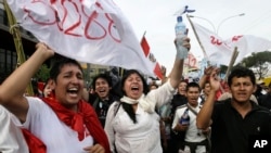 Students celebrate outside Congress after a new labor law affecting young workers was repealed by lawmakers in Lima, Peru, Jan. 26, 2015. 