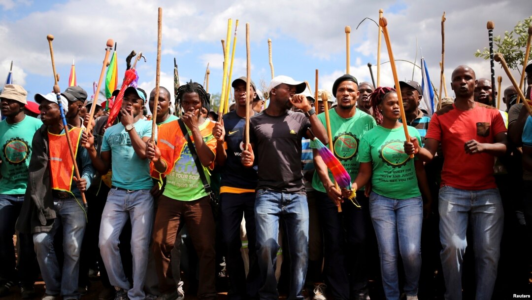 Mine workers gather at Wonderkop stadium outside the Lonmin mine in Rustenburg, northwest of Johannesburg, Jan. 29, 2014. 