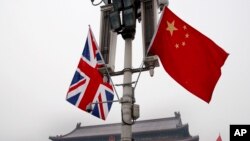 FILE - British and Chinese national flags on display at the Tiananmen Gate in Beijing, China, Jan. 17, 2008. Beijing confirmed on Jan. 26, 2024, that British businessman Ian Stones had been sentenced to five years in prison in 2022 on an espionage charge.