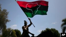 (FILE) Rein Morton waves a Pan-African flag on horseback during a Juneteenth celebration in Los Angeles, Friday, June 19, 2020.