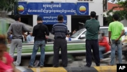 Journalists wait in front of Cambodia National Rescue Party (CNRP) during the party's meeting, in Phnom Penh, Cambodia, Thursday, May 26, 2016. 