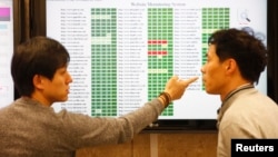 Researchers of Hauri, an IT security software company investigating computer viruses, talk at their lab in the company in Seoul, March 22, 2013. 