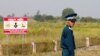 FILE - A Vietnamese soldier stands guard at the dioxin-contaminated area near Bien Hoa airbase, where the U.S. Army stored the defoliant Agent Orange during the Vietnam War, in Bien Hoa city, outside Ho Chi Minh City, Vietnam, October 17, 2018.