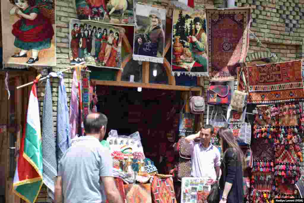 A store in the souq sells traditional patterned fabrics and portraits of important people, in Irbil, Iraq. &nbsp;