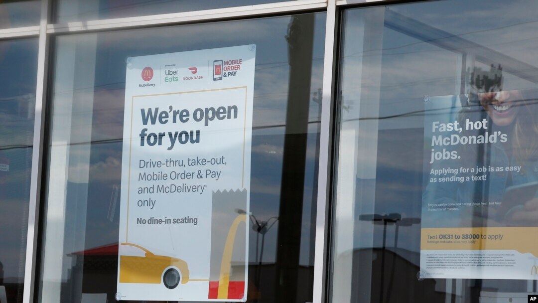 A sign in the window at a McDonald's restaurant states no dine-in seating May 7, 2020, in Oklahoma City, where three employees suffered gunshot wounds when a customer opened fire because she was angry that the restaurant's dining area was closed.
