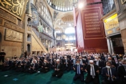 In this Presidential Press Office handout picture, Turkish President Tayyip Erdogan attends Friday prayers at Hagia Sophia Grand Mosque in Istanbul, July 24, 2020.