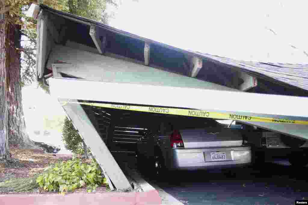 A vehicle is trapped beneath a collapsed parking structure in Napa, California, Aug. 24, 2014.