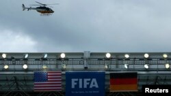 A police helicopter flies over the roof of the Arena Pernambuco before the German national soccer team start their training session in Recife, June 25, 2014. 