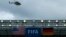 A police helicopter flies over the roof of the Arena Pernambuco before the German national soccer team start their training session in Recife, June 25, 2014. 