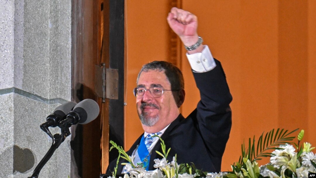 FILE - Guatemala's President Bernardo Arevalo gestures at supporters from a balcony of the Miguel Angel Asturias Cultural Center in Guatemala City, after the inauguration ceremony, Jan. 15, 2024.