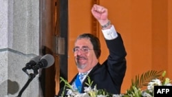 Guatemala's new President Bernardo Arevalo gestures at supporters from a balcony of the Miguel Angel Asturias Cultural Centre in Guatemala City, after the inauguration ceremony, early on Jan. 15, 2024.