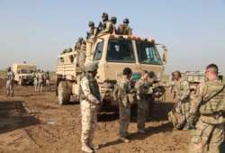 FILE - Iraqi soldiers participate in an exercise with American and Spanish trainers at Basmaya base, southeast of Baghdad, Iraq, Jan. 24, 2016.