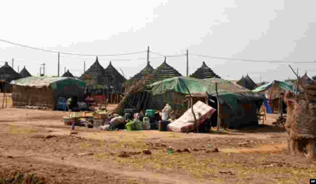 Belongings from recent returnees are left outside because there is no room to for them in the small traditional one-room dwellings called "tukus."