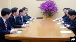 In this photo provided by South Korea Presidential Blue House via Yonhap News Agency, Kim Yong Chol, vice chairman of North Korea's ruling Workers' Party Central Committee, second from right, talks with South Korean delegation in Pyongyang, North Korea.