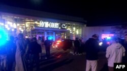 This image from video provided by KSTP 5 television in Minneapolis, Minnesota, shows people standing outside the scene of a stabbing at the Crossroads Center mall in St. Cloud, Minnesota.