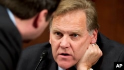 FILE - House Intelligence Committee Chairman Rep. Mike Rogers, R-Mich., right, confers with committee member Rep. Devin Nunes, R-Calif., during their committee’s hearing on Capitol Hill about terrorist attacks on U.S. facilities in Benghazi, April 2, 2014