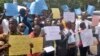 FILE - Liberians stage a protest outside the National Assembly against the government not doing enough to fight Ebola virus in Monrovia, Liberia, Oct. 9, 2014.