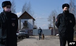 FILE - Russian police officers guard the entrance to the penal colony N2, where Kremlin critic Alexey Navalny has been transferred to serve a two-and-a-half year prison term for violating parole, in the town of Pokrov, April 6, 2021.