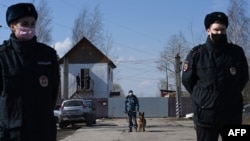 FILE - Russian police officers guard the entrance to the penal colony N2, where Kremlin critic Alexey Navalny has been transferred to serve a two-and-a-half year prison term for violating parole, in the town of Pokrov, April 6, 2021.