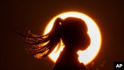 FILE - Environmentalists read an oath for 'climate action' during an event to mark the 50th anniversary of Earth Day, in Seoul, South Korea, April 22, 2020. 