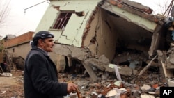 A resident walks on the rubble of a destroyed house in the mostly Kurdish town of Silopi, Turkey, Jan. 19, 2016. Turkey's president has ruled out any further peace efforts with Kurdish rebels.