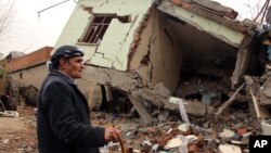 A resident walks on the rubble of a destroyed house in the mostly-Kurdish town of Silopi, Turkey, Jan. 19, 2016. Turkey's president has ruled out any further peace efforts with Kurdish rebels.