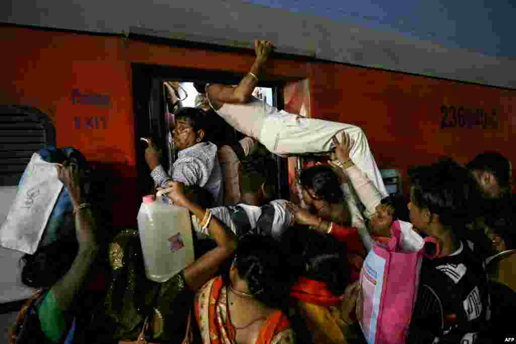 Pilgrims board a train after visiting the Kashi Vishwanath temple, at a railway station in Varanasi, India, Feb. 17, 2025, following their trip from the Maha Kumbh Mela festival in Prayagraj.