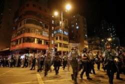 Riot policemen arrive to disperse the residents and protesters at Sham Shui Po district in Hong Kong, Aug. 7, 2019.