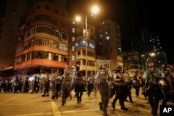 Riot policemen arrive to disperse the residents and protesters at Sham Shui Po district in Hong Kong, Aug. 7, 2019.