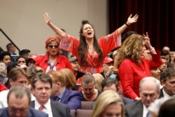 A member of the audience stands at an Evangelicals for Trump Coalition Launch at the King Jesus International Ministry in Miami, Florida, January 3, 2020.