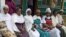 Latrines, safe delivery of babies and children's vaccinations are this Dosha health 'army's' normal discussion agenda. (VOA/Joana Mantey)