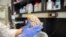 Researcher holds human brain in laboratory at Northwestern University's cognitive neurology and Alzheimer's disease center, Chicago, July 29, 2013 file photo.
