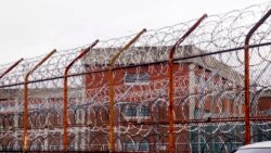 FILE - In this March 16, 2011, file photo, a security fence surrounds inmate housing on the Rikers Island correctional facility in New York. New York City lawmakers are considering a plan to close the notorious Rikers Island jail complex and replace it…