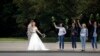 A newly wed couple kisses as opposition supporters hold flowers during a protest in Minsk, Belarus.