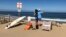 Two people look out at the shore after a shark attack at Newcomb Hollow Beach in Wellfleet, Mass, Sept. 15, 2018. A man boogie-boarding off the Cape Cod beach was attacked by a shark on Saturday and died later at a hospital, becoming the state’s first shark attack fatality in more than 80 years.