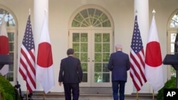 President Joe Biden and Japanese Prime Minister Yoshihide Suga leave after a news conference in the Rose Garden of the White House, April 16, 2021, in Washington.
