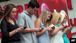  Texting can lead to strain and injury, otherwise known as text neck. Here contestants compete in a texting championship in New York, Aug. 8, 2012.