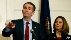 FILE - Virginia Gov. Ralph Northam, left, gestures as his wife, Pam, listens during a news conference in the Governors Mansion at the Capitol in Richmond, Virginia, Feb. 2, 2019.