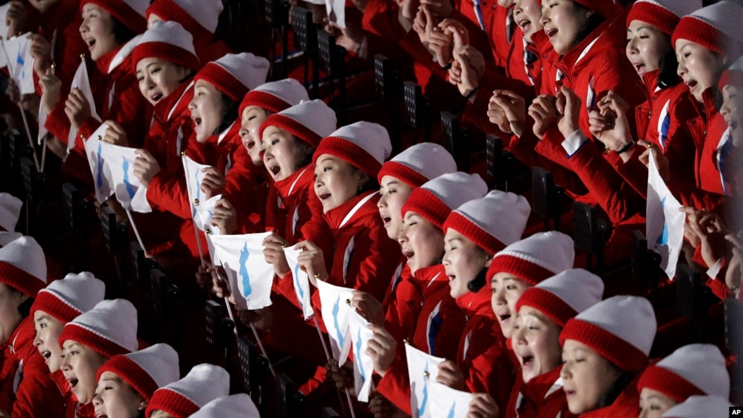 North Korean cheerleaders sing in unison before the opening ceremony of the 2018 Winter Olympics in Pyeongchang, South Korea, Friday, Feb. 9, 2018.