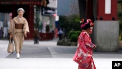 A child in colorful kimono walks at Tokyo&#39;s Asakusa district, Japan, on the occasion of Shichigosan celebration.