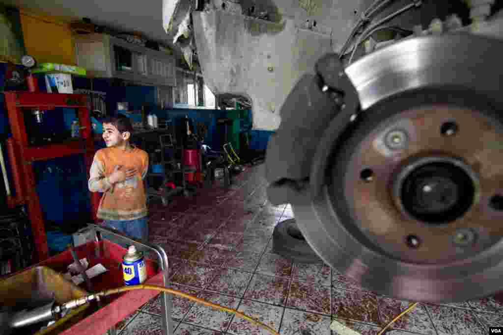 Hamad at the garage he works in. He opens up the garage at 7am and works till 5pm, John Owens/VOA.