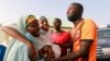 FILE - People react after the arrival of the rescued JSS Jangebe schoolgirls in Jangebe, Zamfara, Nigeria, March 3, 2021.