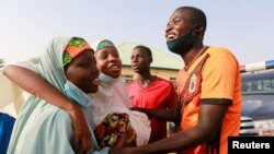 FILE - People react after the arrival of the rescued JSS Jangebe schoolgirls in Jangebe, Zamfara, Nigeria, March 3, 2021.