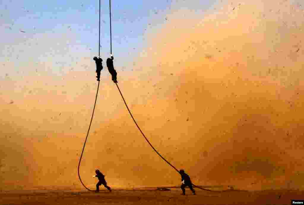 Yonif 700/Raider soldiers descend from a helicopter using a rope during a counter-terrorism drill at the University of Hasanuddin in Makassar, South Sulawesi, Indoensia, in this photo taken by Antara Foto.