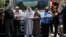 Palestinians stand next to a police barricade as they wait for the compound known to Muslims as Noble Sanctuary and to Jews as Temple Mount to be reopened, in Jerusalem's Old City, July 16, 2017.