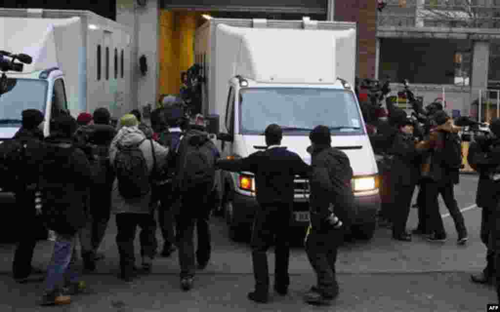 Members of the media gather around a prison van as it leaves the rear entrance of Westminster Magistrates Court in London, Tuesday, Dec. 7, 2010, where WikiLeaks founder Julian Assange was denied bail after appearing on an extradition warrant. Assange sur