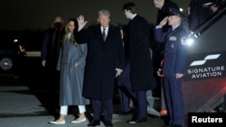 U.S. President-elect Donald Trump, center, waves as he arrives at Washington Dulles International Airport in the state of Virginia, Jan. 18, 2025.