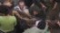 In this image taken from video, people carry a child's body pulled out from rubble following Saudi-led coalition airstrikes that killed dozens, including children, in the residential center of the capital, Sanaa, Yemen, May 16, 2019.