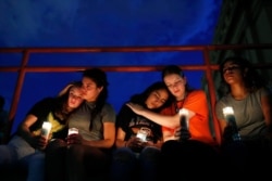 From left, Melody Stout, Hannah Payan, Aaliyah Alba, Sherie Gramlich and Laura Barrios comfort each other during a vigil for victims of the shooting, Aug. 3, 2019, in El Paso, Texas.